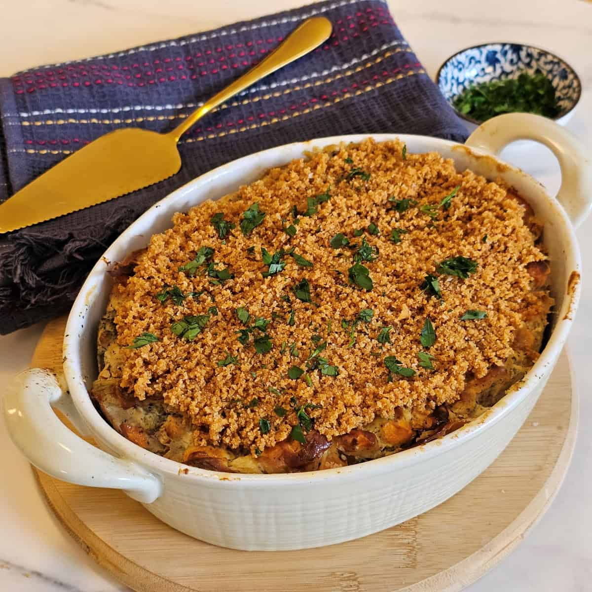 Vegan sweet potato and broccoli casserole topped with golden crispy breadcrumbs, whole and ready to serve.